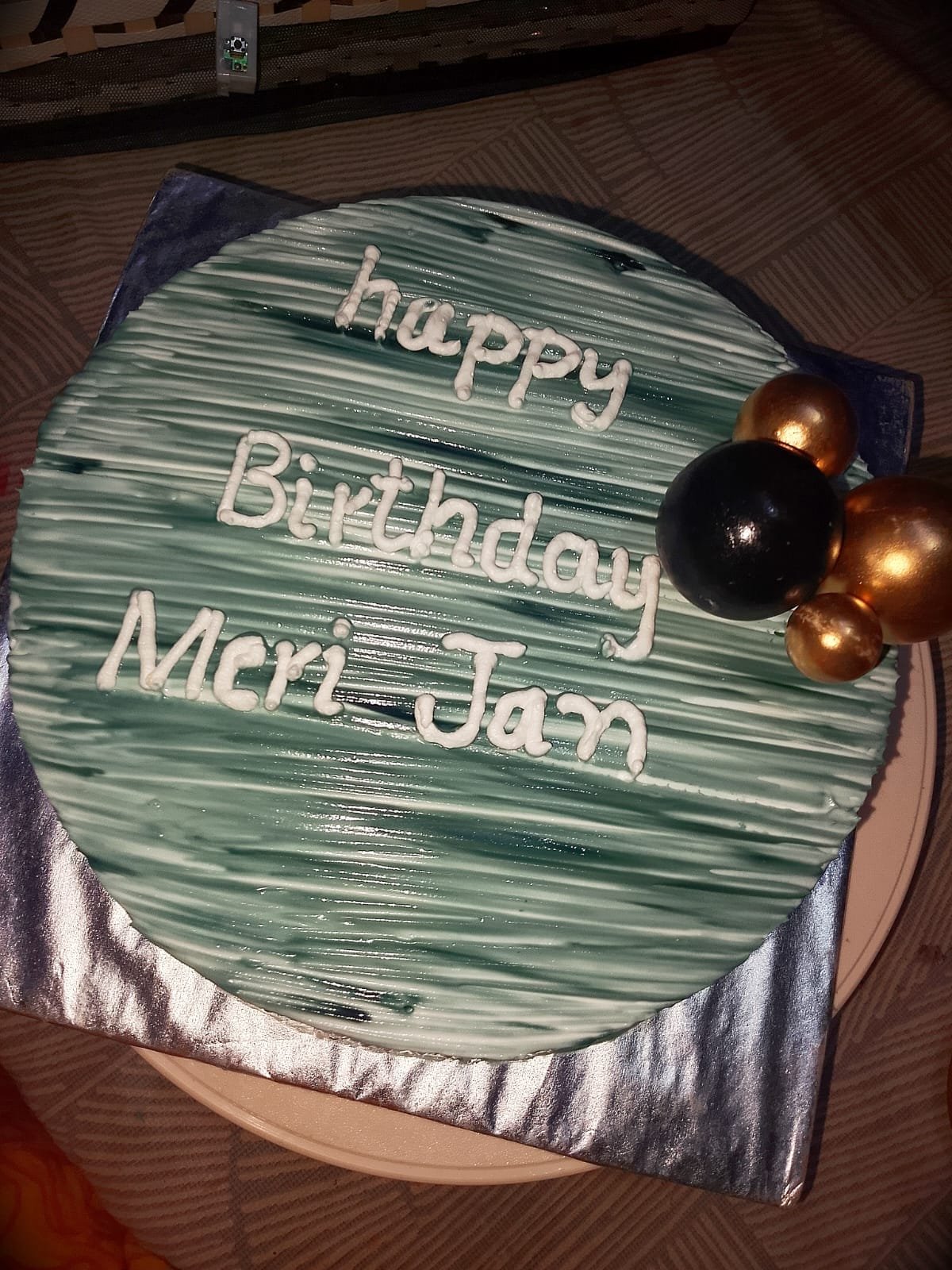 Teal textured buttercream birthday cake with gold sphere decorations and a hand-piped message